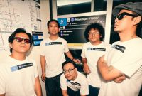 Foto memperlihatkan kelima personil D'Masiv berdiri di depan plakat nama halte TransJakarta yang baru, "Petukangan D'Masiv", sebagai bagian dari perayaan ulang tahun ke-22 band.  (Instagram/rianekkypradipta)