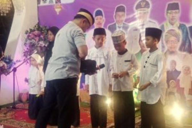 Camat Kemiri, Hendarto, S. STP., M. Si, menyerahkan santunan simbolis kepada anak-anak yatim dalam acara penutupan Pesantren Ramadan di Padepokan Macan Putih Kemiri.
