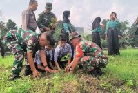 Anggota Koramil 11/Pasar Kemis bersama siswa SMPN 3 Pasar Kemis dan aparat terkait menanam bibit pohon secara gotong royong.