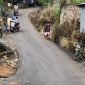 Warga membantu pengendara melintasi tanjakan licin pascahujan di jalur menuju Pasar Agro, Enrekang.