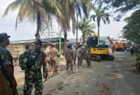 Personel gabungan TNI, Satpol PP, dan instansi terkait bersiaga saat proses pembongkaran bangunan liar di kawasan Jalan Raya Puri Jaya, Pasar Kemis.
